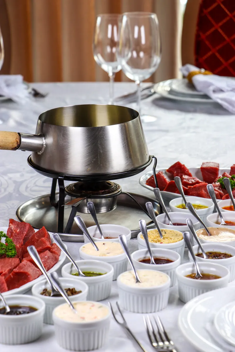 Fondue Bourguignonne with filet mignon cubes and sauces